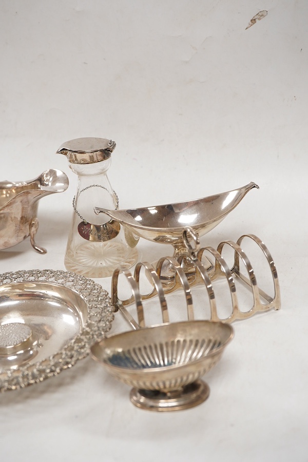 A group of assorted small silver including an Elizabeth II small circular dish by Stuart Devlin, London, 1985, diameter 13.5cm, a sauceboat, a 1920's seven bar toastrack, two pedestal salts including late Victorian, an e